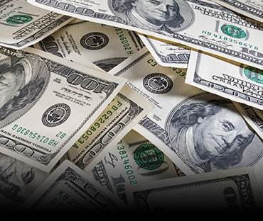 pile of one hundred dollar bills